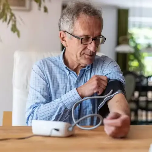 Man fitting the blood pressure cuff around his upper arm