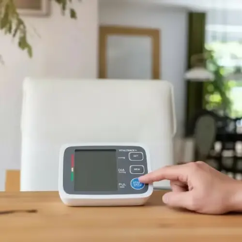 Pressing the start button on the Vitaltrack blood pressure monitor